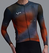 Race Division men's long-sleeve training cycling jersey, blue/orange grid closeup — breathable UPF 30+ REPREVE recycled polyester microfiber, perforated panels, four-way stretch, silicone gripper hem, extended sleeves, all-season performance