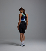 Back view of women's black Race Division training bib shorts with bonded Grid Mesh back brace, premium Italian compressive fabric, multi-density 4+ hr chamois, Race Fit 24cm inseam, laser-cut seamless cuffs with silicone grippers and reflective logos