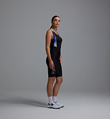 Women's Race Division black training bib shorts side view, race-fit 24cm inseam, premium Italian compressive fabric, bonded Grid Mesh bib braces, 4+ hr multi-density chamois, SuperGRIP laser-cut cuffs, reflective logos