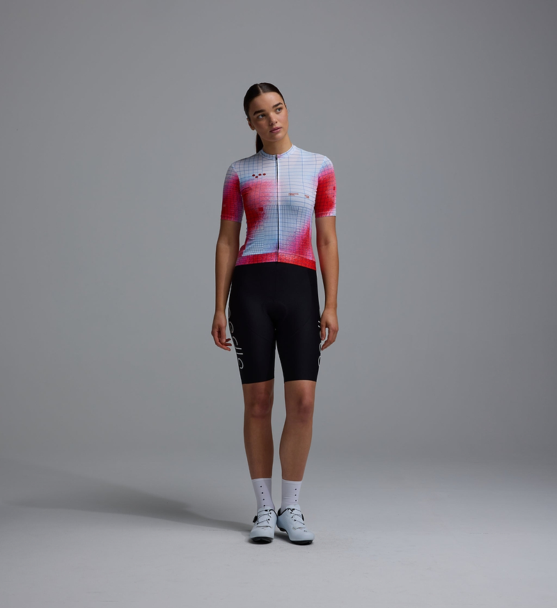 Women's Race Division red grid training cycling jersey, full-zip short-sleeve with breathable perforated panels, UPF 30+ sun protection, moisture-wicking REPREVE recycled polyester, silicone gripper hem, four-way stretch