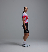 Race Division women's red grid training cycling jersey, side view - short-sleeve performance jersey with UPF 30+, REPREVE recycled polyester, breathable perforated panels, moisture-wicking microfiber, silicone gripper hem