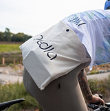 Pedla natural canvas cycling musette — lightweight feed-zone bag with long shoulder strap for one-handed access; carries food, gels and race-day essentials