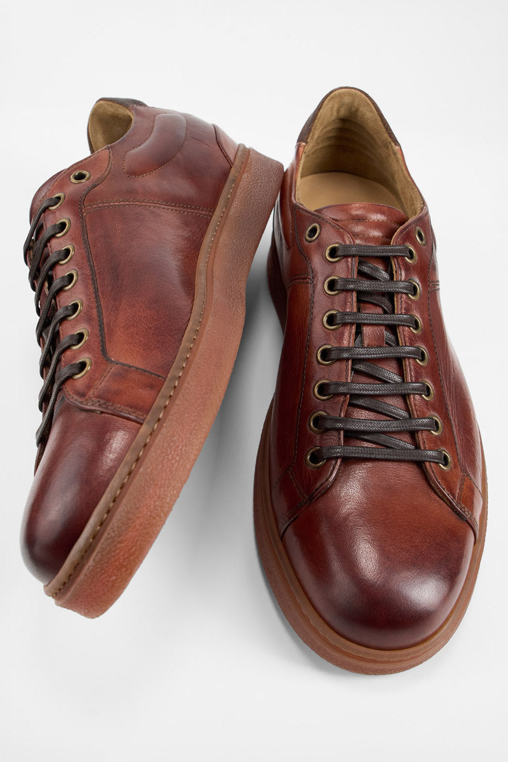 CREED cognac distressed sneakers.