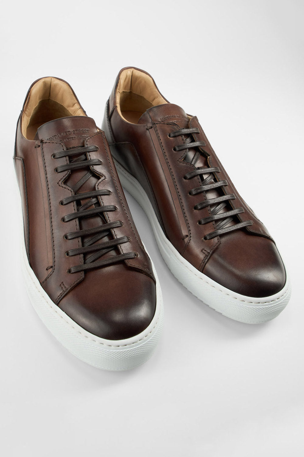 SKYE noble-brown triple stitched patina sneakers.