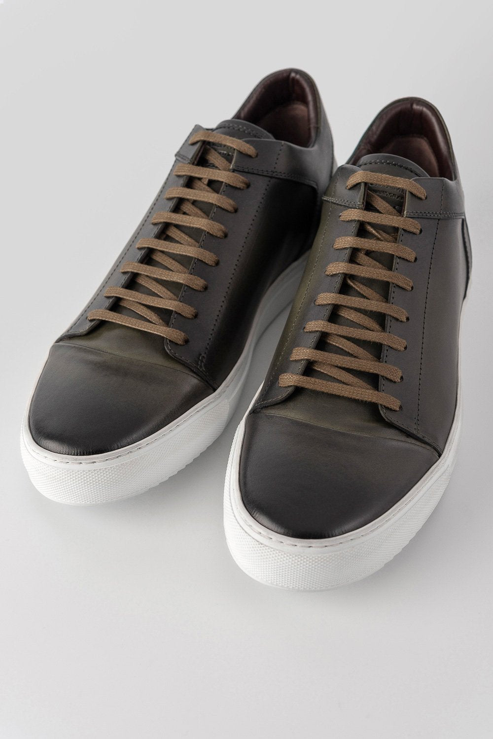 SOHO forest-green cap toe patina sneakers.