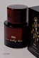 NFD Eau De Parfum 001 in a dark amber bottle with a marbled cap and gold script, beside its black and gold illustrated box.