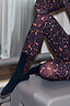 Thumbnail for Black crew-length cotton socks featuring a leopard print side panel, styled with matching leopard activewear.