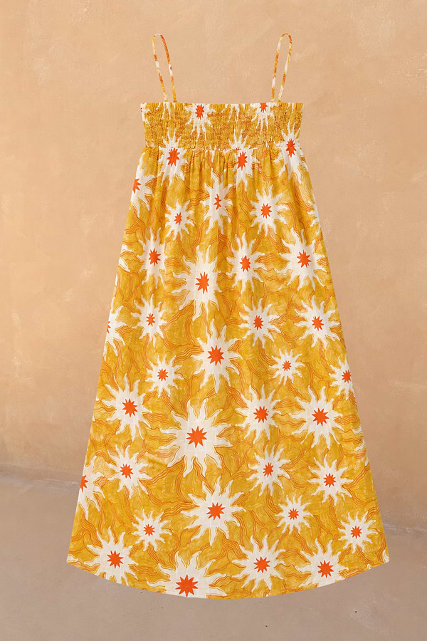 Girl's yellow cotton maxi sun dress with an orange sun print, featuring a shirred bodice and thin straps.