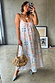White Island Cross Stitch Maxi Dress with tropical prints and rope strap detailing in a mirror selfie.