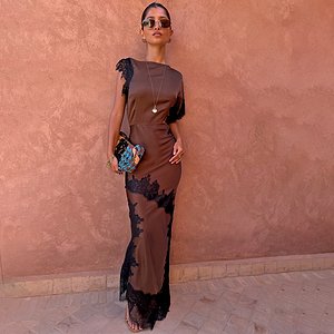Chocolate and Black Lace Fearne Maxi Dress with cap sleeves and lace detailing against a textured terracotta wall.