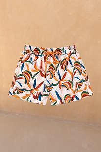 Boy's cream swim shorts with a multi-coloured banana print, elasticated waistband and orange drawstring.