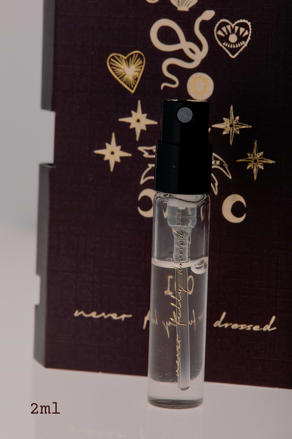 NFD Eau De Parfum 001 2ml tester vial with gold script on a dark celestial illustrated background.