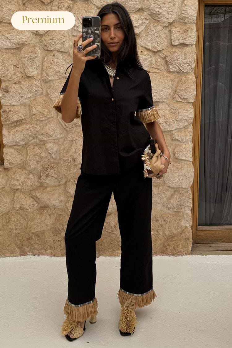 Black Raffia Marra Trousers featuring tan raffia fringe at the hem, styled with a matching shirt and accessories.