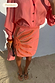 Pink Sol Beaded Wrap Skirt featuring hand-embroidered sun details, styled as a vacation co-ord on the beach.