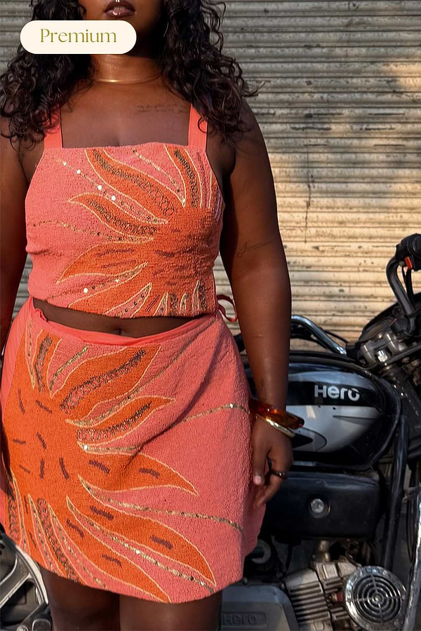 Pink Sol Beaded Top and skirt co-ord with hand-embroidered sun motifs and gold sequins, shown on a model.