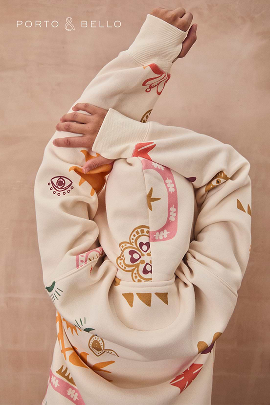 Cream Sundazed Accessible Hoodie with colourful sun, eye and star prints, showing a close-up of the back and hood.