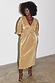 Gold Plisse Dress featuring angel sleeves and a belted waist on a model.