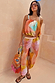 Abstract Balloon Trousers in pink and amber sunset tones with a relaxed tapered fit, designed in London for vacation.