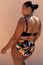 Banana High Waisted Bikini Bottoms with a multi-colour banana print on black, shown on a model for inclusive sizing.