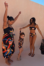 Banana Sarong in a multi-colour print, styled with matching swimwear for inclusive family dressing.