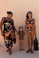 Banana Sarong in black cotton with a multi-colour banana print and wrap tie, styled for inclusive sizing.
