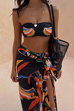 Banana Sarong featuring a vibrant multi-colour print on a black base, styled with a wrap tie and blanket stitching.
