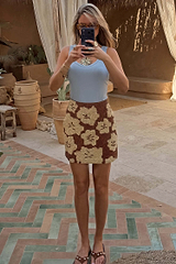 Brown Jaden Beaded Skirt with cream floral beadwork, styled with a blue ribbed tank top for a holiday look.