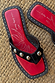 Black Leather Stud Sandals with silver studs, a square toe and a red graphic footbed on a woven mat.