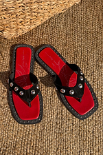 Black Leather Stud Sandals with silver studs and a red square-toe footbed on a woven mat.