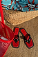 Black Leather Stud Sandals featuring a square toe and silver studs on a red footbed, styled with a beach bag and mat.
