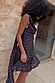 Black Rose Mini Sophie Dress featuring a red rose print, cowl neckline and draped scarf detail on a model.