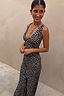 Thumbnail for Black Spot Boni Dress with a red-detailed spot print, featuring a deep V-neckline and bias-cut fit, worn by a model.