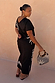 Black cotton Dolce Vita T-Shirt Dress with hand-painted sun motifs and Greek graphics, shown on a size XL model.