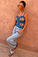 Blue Eye Knitted Cami Top with gold eye motifs, styled with light-wash denim jeans and sunglasses.