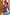 Thumbnail for Blue Eye Knitted Cami Top with iconic eye and heart motifs, styled on a smiling model in a mirror selfie.