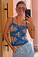 Blue Eye Knitted Cami Top with iconic eye and heart motifs, styled on a smiling model in a mirror selfie.