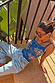 Blue Eye Knitted Cami Top with woven eye and heart motifs, styled with light-wash jeans on outdoor stairs.