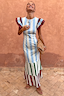 Blue Stripe Alena Midi Dress featuring ruffle sleeves and a multi-coloured tiered skirt against a textured wall.