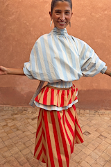 Blue Stripe Batwing Blouse with a high tie neck and shirred waist, styled with a contrasting red striped skirt.