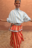 Blue Stripe Batwing Blouse with a high tie neck and shirred waist, styled with a contrasting red striped skirt.