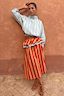 Blue Stripe Batwing Blouse with shirred cuffs and a smocked waist, paired with a red striped ruffled skirt.