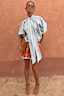 Blue Stripe Batwing Blouse with a long neck tie and voluminous sleeves, styled with contrasting red striped shorts.