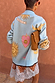 Blue Mystical Cardigan featuring sun and moon jacquard motifs, a pink heart and 'Moonchild' banner on the back.