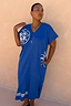Blue Dolce Vita cotton T-Shirt Dress with white Greek motifs and side pockets, highlighting inclusive sizing.