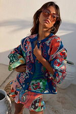 Blue Mari Cardigan featuring a deep blue paisley print with orange and turquoise tones and a button-up front.