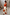 Thumbnail for Blurred Floral Midi Skirt in cream cotton with large orange prints, styled with an orange tank top and side pockets.