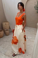 Blurred Floral Midi Skirt in cream cotton with large orange prints, styled with an orange tank top and side pockets.