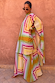 Bright Geo Stevie Maxi Dress with a multi-coloured geometric stripe print and cape sleeves on a model.