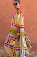 Bright Geo Stevie Maxi Dress with a colourful geometric stripe print, scarf-tie neck and cape sleeves.