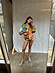 Fiji Elissa Shorts in a multi-coloured print with orange rick rack trim, styled as a co-ord in a mirror selfie.